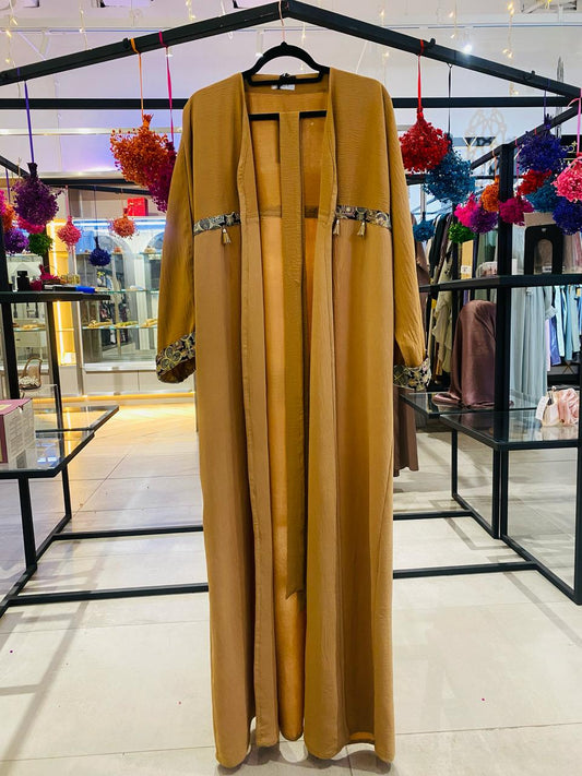 Tan abaya with brocade and tassel details