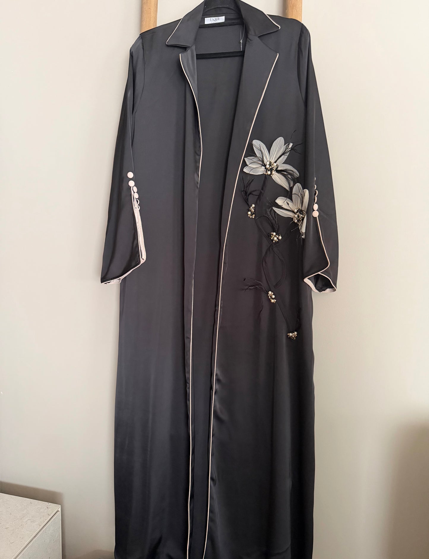 Detailed feather and flower abaya